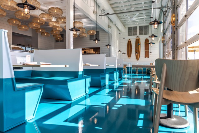 Rocketts Landing Restaurant exterior. This tropical themed ISCO location includes ocean-inspired blue flooring and accents. 